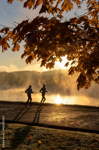 Morning jog along the river bank in the morning fog