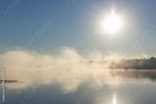 Dawn fog on the river. Fog illuminated by the sun