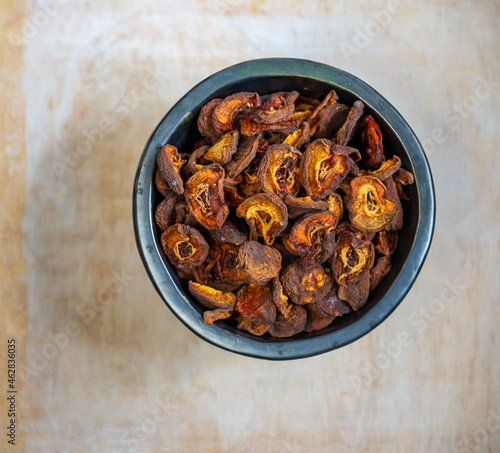 Dried apricots in rustic dark plate