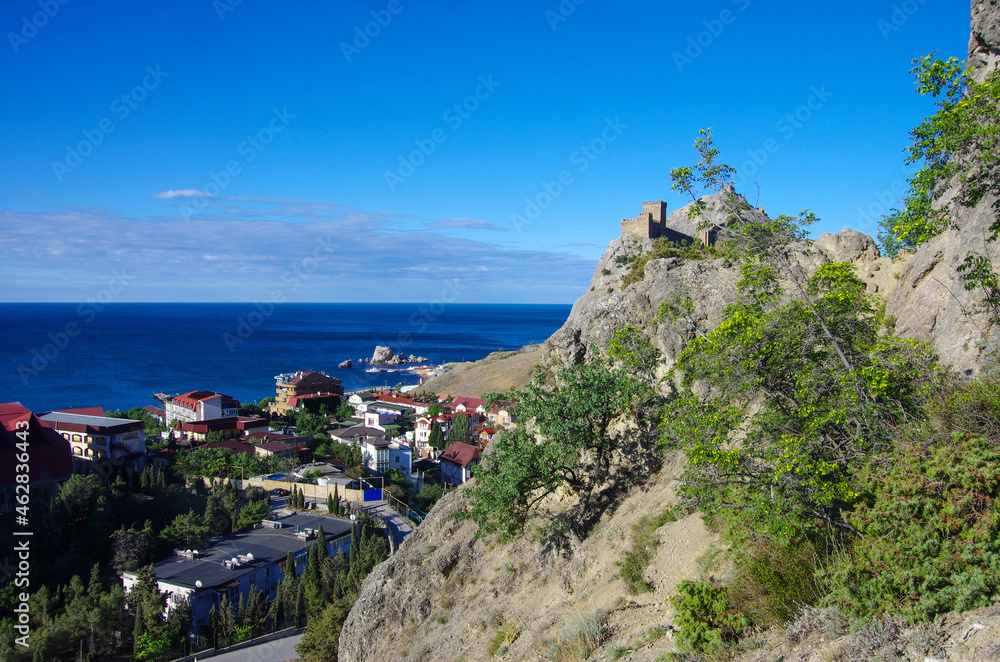 SUDAK, CRIMEA - July, 2020: Aereal view of the street of the city and Genoese fortress in summer sunny day