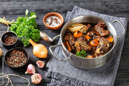 beef broth of beef meat on bones with spices photo