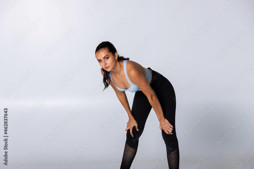 Fit woman standing in sportswear looking strong on white background, fitness trainer isolated and confident Fit woman standing in sportswear looking strong on white background, fitness trainer isolated and confident