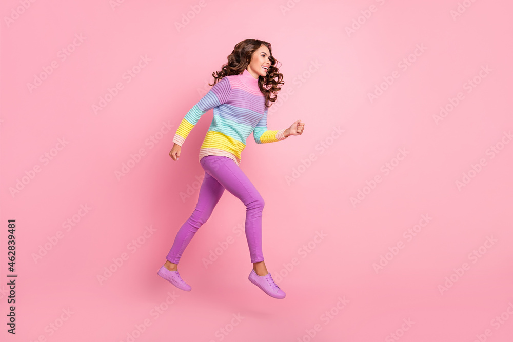 Full length profile side photo of young girl hurry run jump look empty space discount isolated over pastel color background