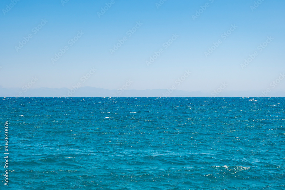 Obraz premium A calm azure sea at dawn in the morning. Copy space. Space for text.