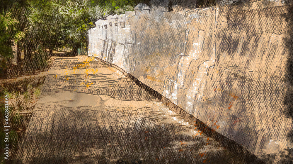 Obraz premium Empty sidewalk along a white stone fence.