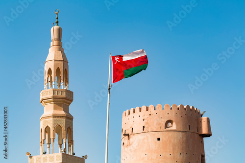 Sultanate Of Oman, Ras al Hadd, Ras al Hadd Castle with Omani flag and minaret photo