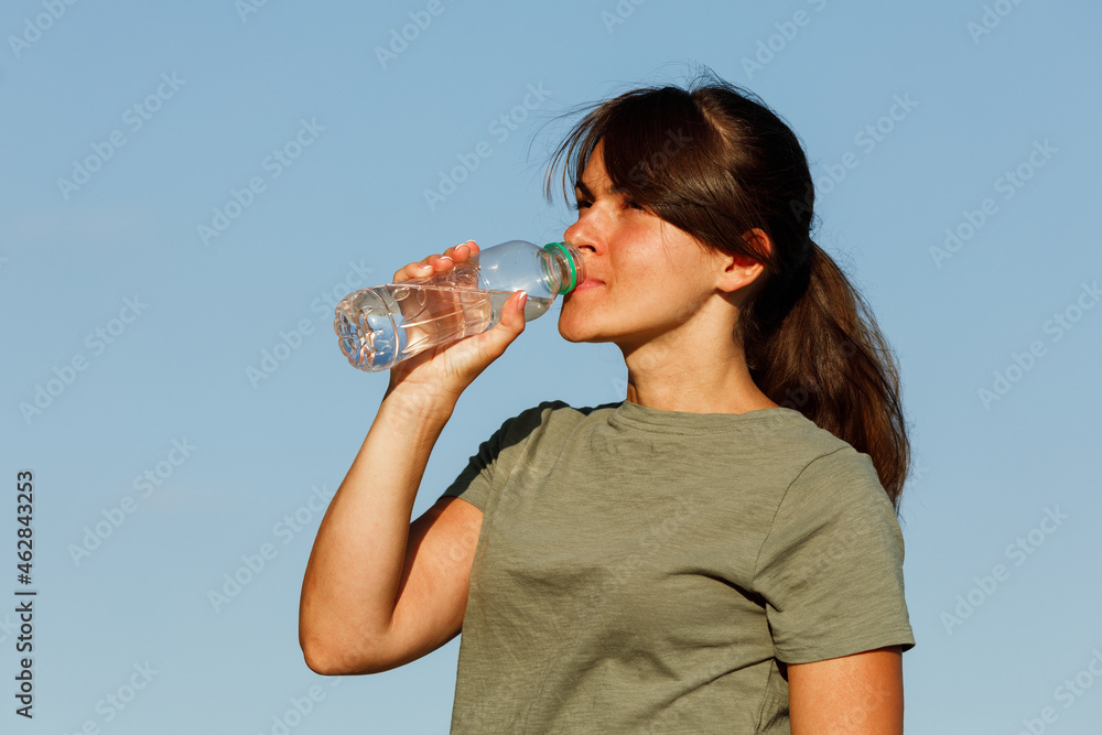 a girl drinks water after sport. healthy active lifestyle