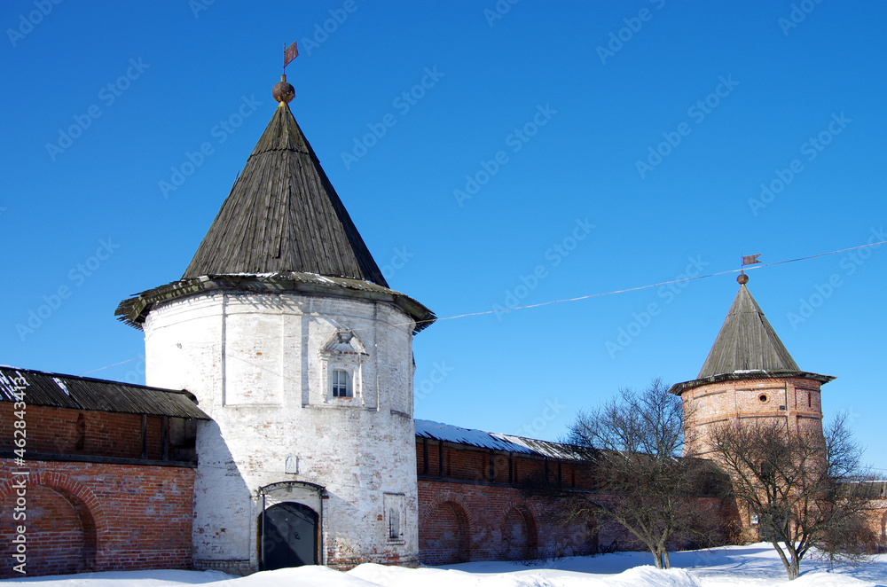 Yuryev-Polsky, Vladimir Oblast, Russia - March, 2021: Mikhailo - Arkhangelskiy Monastery in winter sunny day.  Kremlin tower and wall