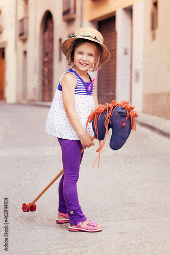 Portrait of little girl with hobby horse