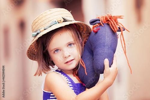 Portrait of little girl with hobby horse photo