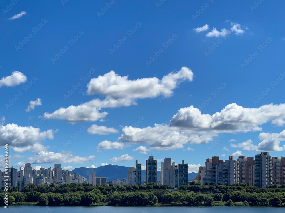 Fototapeta premium city skyline with beautiful white clouds in the blue sky