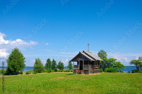 Kizhi, Karelia, Russia - July, 2021: Chapel of Peter and Paul of Berezhnaya and Oshevnev's house on Kizhi Island