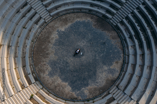 Businessman lying at BergArena amphitheater photo