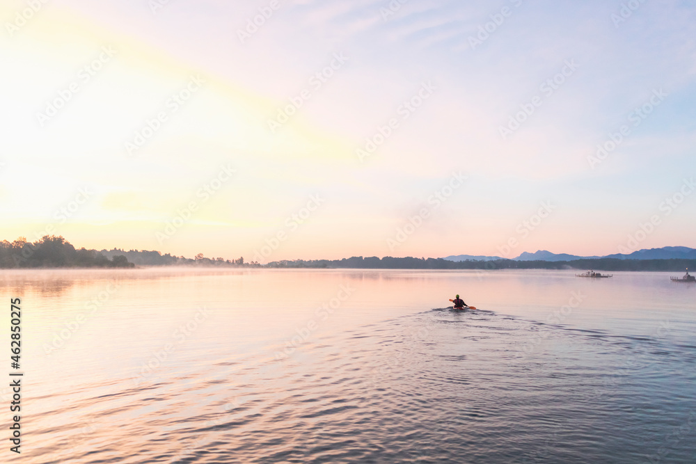 Kayaker in the morning on a lake, Germany Kayaker in the morning on a lake, Germany