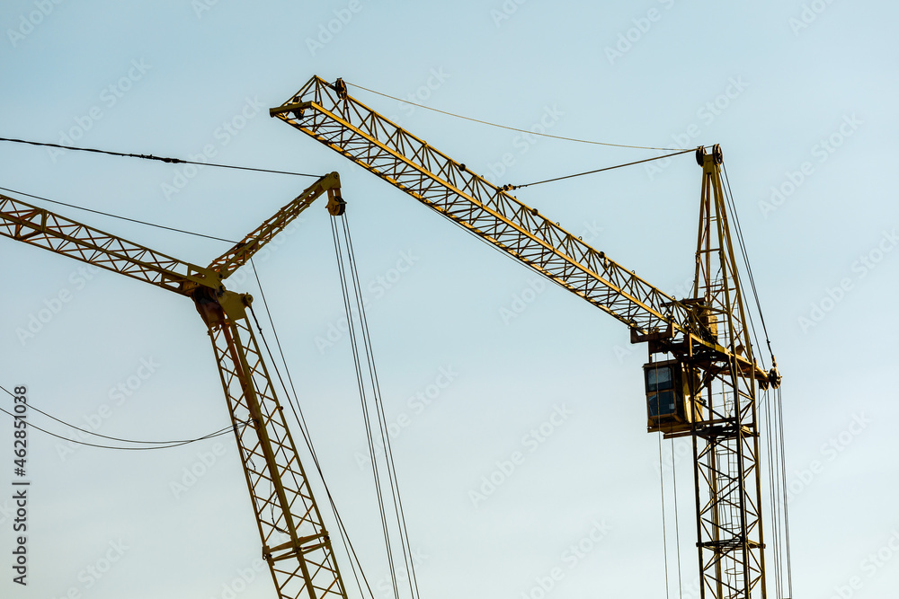 construction site with cranes against the background of new buildings
