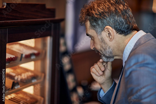 Businessman looking at cigar humidor
