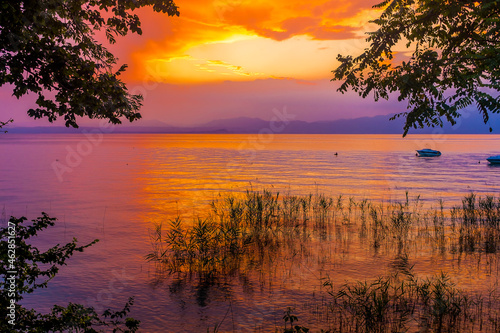 Italy, Province of Verona, Lazise, Lake Garda at moody sunset