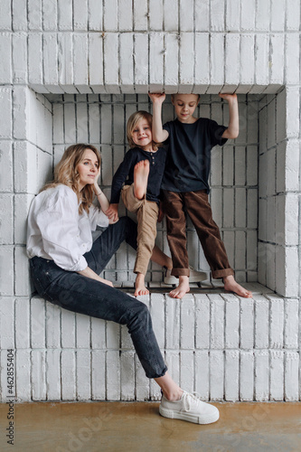 Full length of family on white niche in brick wall at home photo