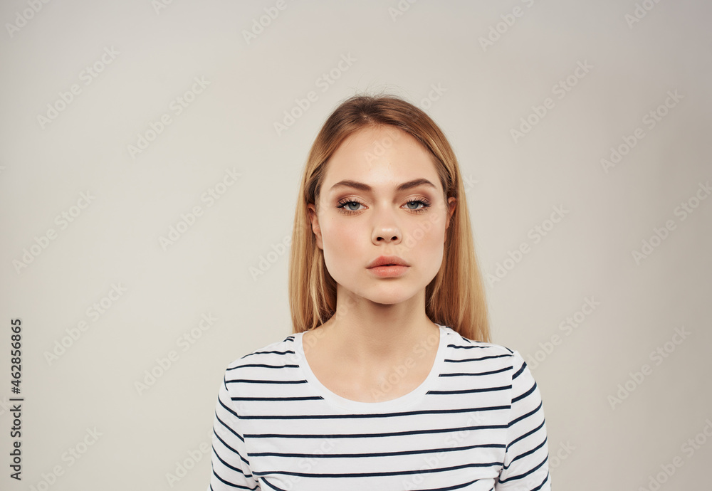 Obraz premium cheerful blonde in a striped t-shirt white sheet Coffee Space advertising