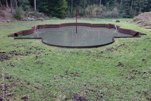 Excavated pond of the trick fountains of Schloß Karlsberg (Karlsberg Castle) in the forests near Homburg, Saarland, Germany 