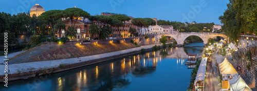 Rome - The Isola Tiberiana - Tiberian Island with the Ponte Cestio bridge at dusk.