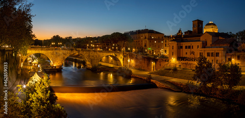 Rome - The Isola Tiberiana - Tiberian Island with the Ponte Cestio bridge at dusk. photo