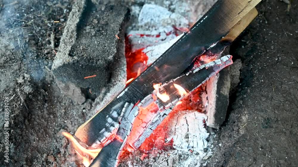 Flames of burning wood logs. Close up burning wood in campfire. Fire. Flames of burning wood logs. Close up burning wood in campfire. Fire.