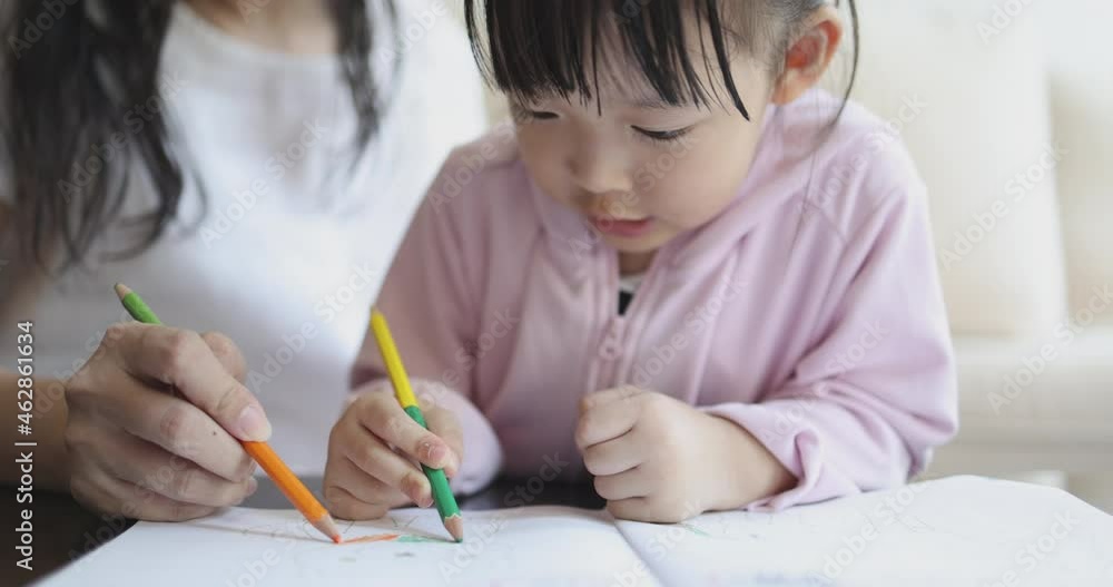 4K Video slow motion Asian mom teach her little daughter draw picture with color pencil. Concept of learning from home and family activity. 4K Video slow motion Asian mom teach her little daughter draw picture with color pencil. Concept of learning from home and family activity.