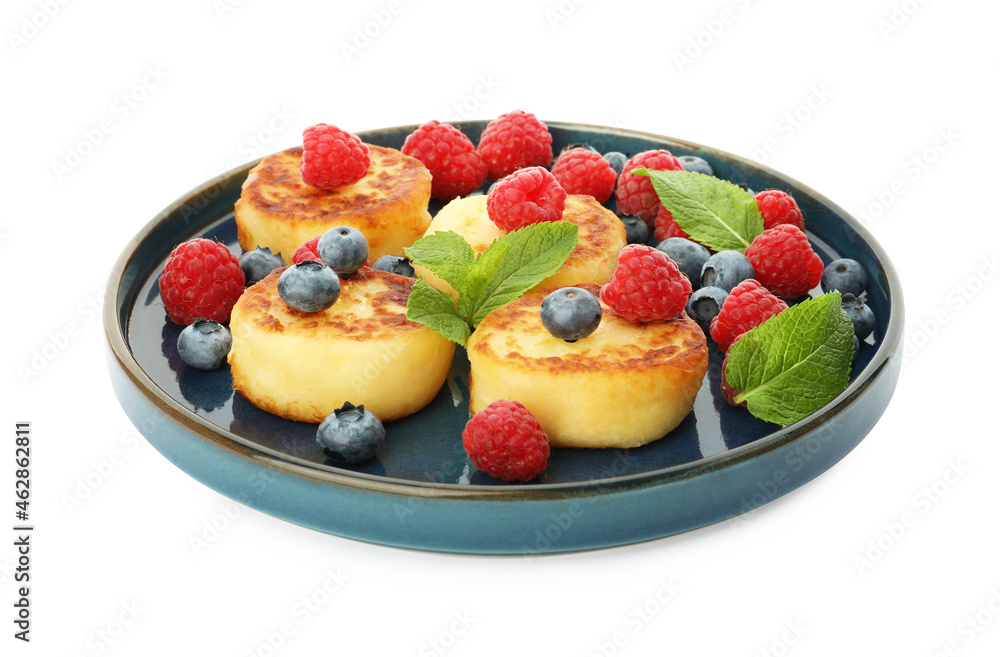 Plate with delicious cottage cheese pancakes, fresh berries and mint on white background