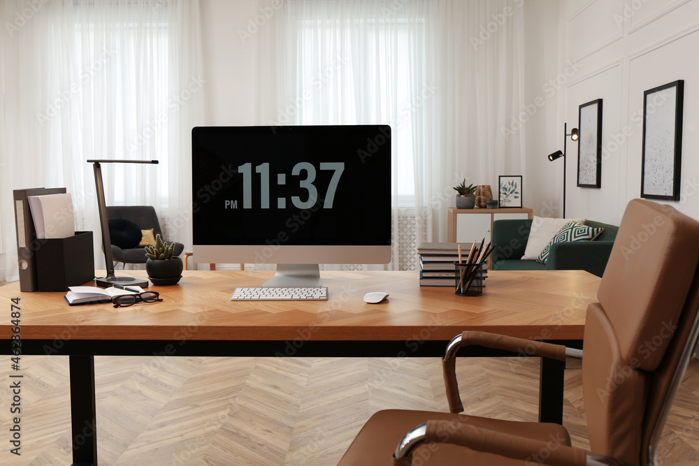 Comfortable workplace with modern computer on wooden desk in room. Interior design Comfortable workplace with modern computer on wooden desk in room. Interior design