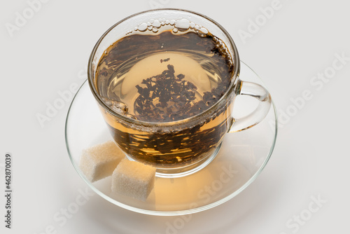 light ceylon leaf tea in a cup with sugar cubes, natural color.