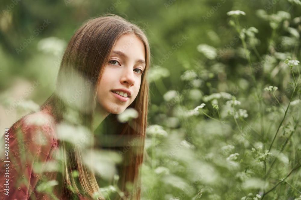 teenage girl among flowers enjoying the scent teenage girl among flowers enjoying the scent