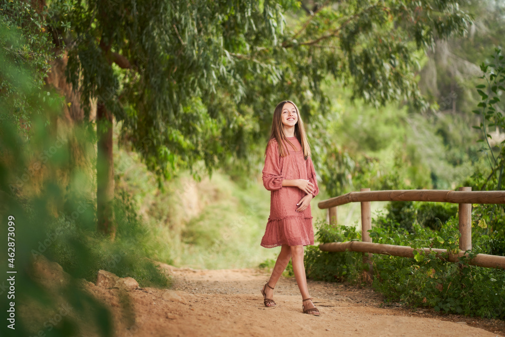 a teenage girl walking along a trail in the countryside a teenage girl walking along a trail in the countryside