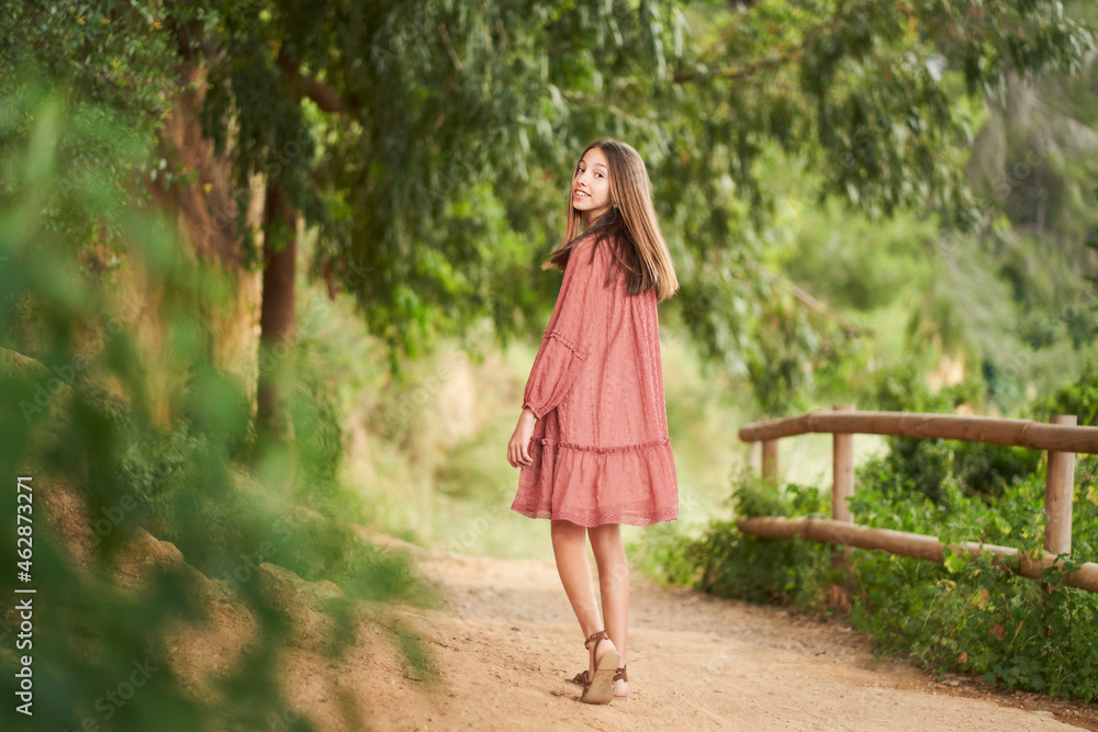 a teenage girl walking along a trail in the countryside a teenage girl walking along a trail in the countryside