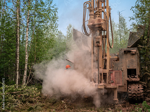 Crawler drilling rig drills a well, a lot of dust when drilling a borehole photo