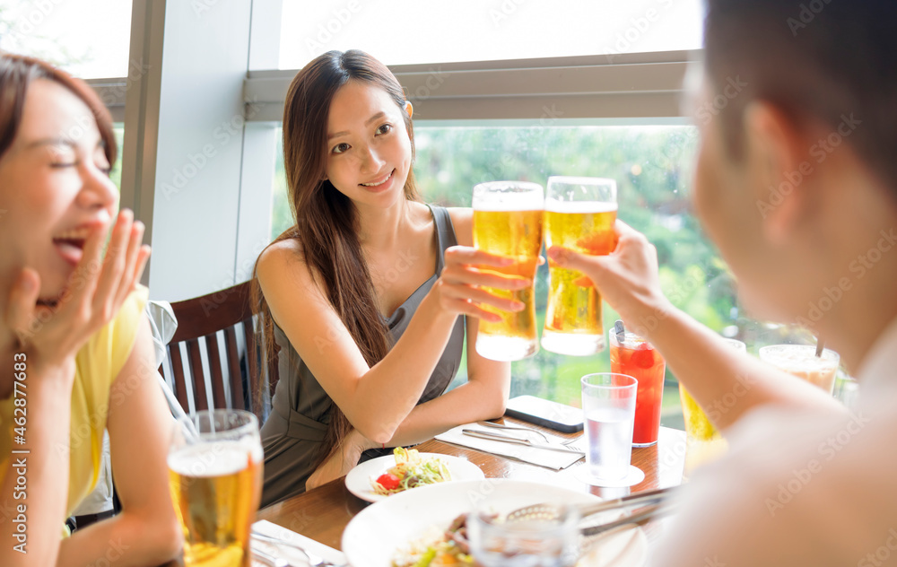 People enjoying food and drink in restaurant People enjoying food and drink in restaurant