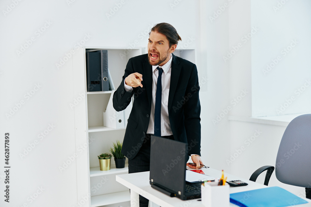 man in a suit in the office with documents technologies man in a suit in the office with documents technologies