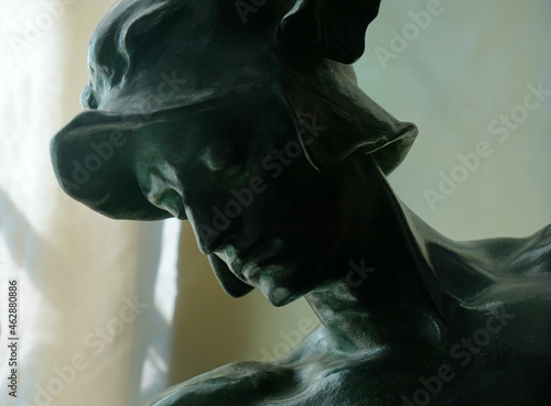 Head of statue of Eros close up. photo