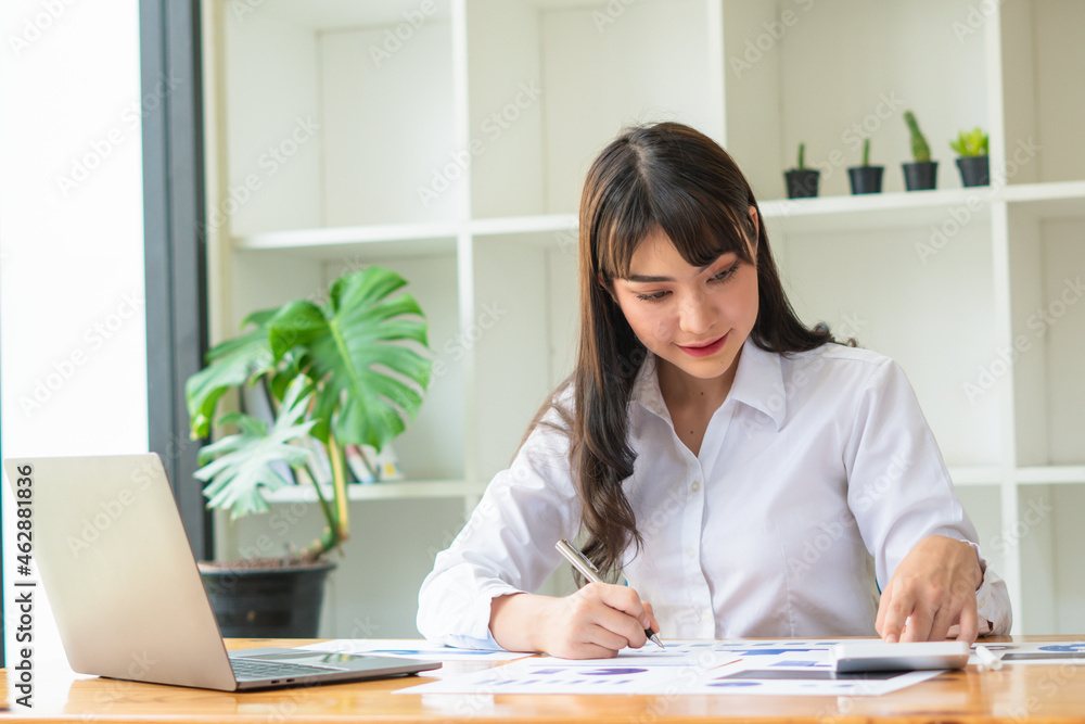 Confident businesswoman working on laptop at her workplace at modern office. Confident businesswoman working on laptop at her workplace at modern office.