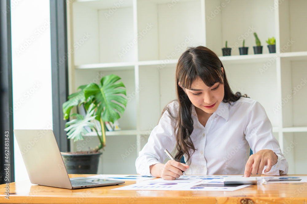Confident businesswoman working on laptop at her workplace at modern office. Confident businesswoman working on laptop at her workplace at modern office.