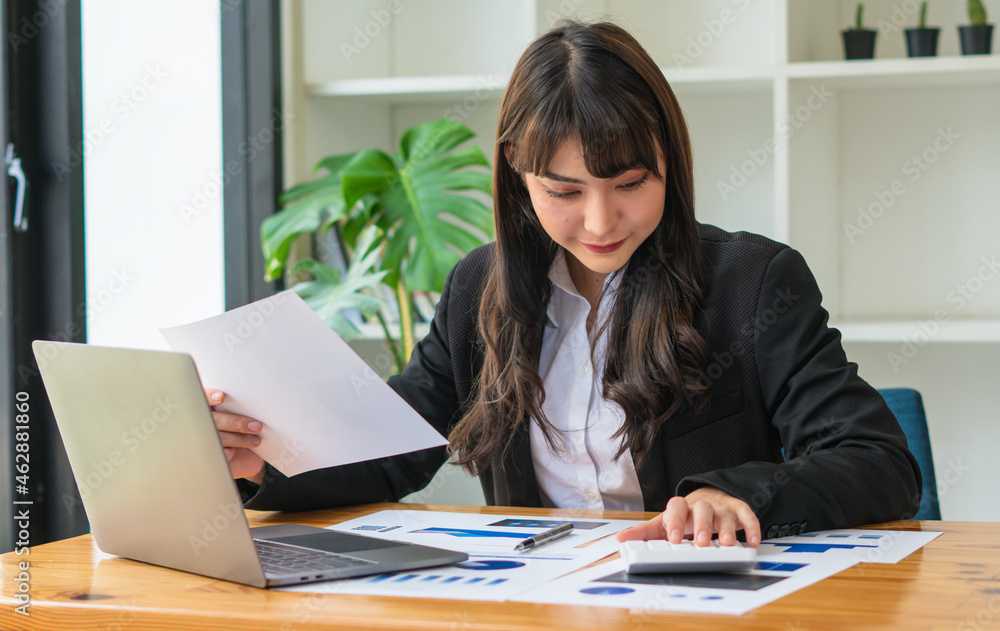 beautiful Asian business women checking document and using notebook and smiling happy for working beautiful Asian business women checking document and using notebook and smiling happy for working