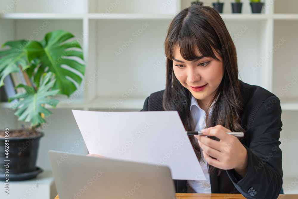 Portrait Of Attractive Asian Businesswoman Working On Laptop for marketing plan Portrait Of Attractive Asian Businesswoman Working On Laptop for marketing plan