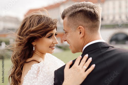 Wedding day, portrait close-up of bride and groom tenderly look at each other, happy together. © Татьяна Волкова