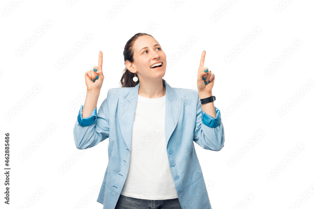 Young woman is pointing up with both hands and making an amazed face. Young woman is pointing up with both hands and making an amazed face.