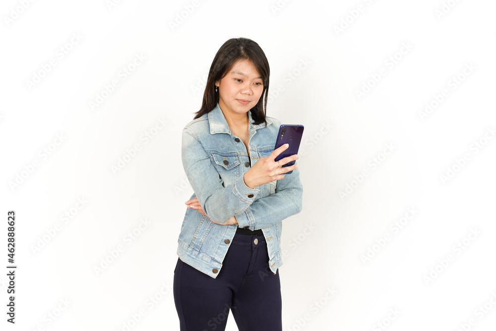 Holding and Using Smartphone of Beautiful Asian Woman Wearing Jeans Jacket and black shirt Isolated On White Background Holding and Using Smartphone of Beautiful Asian Woman Wearing Jeans Jacket and black shirt Isolated On White Background