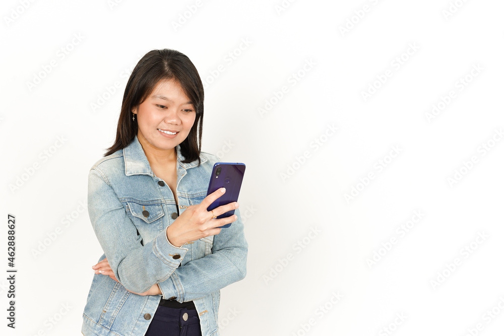 Holding and Using Smartphone of Beautiful Asian Woman Wearing Jeans Jacket and black shirt Isolated On White Background Holding and Using Smartphone of Beautiful Asian Woman Wearing Jeans Jacket and black shirt Isolated On White Background