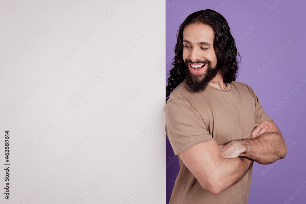 Profile side photo of handsome man folded hands look empty space advert poster isolated on purple color background Profile side photo of handsome man folded hands look empty space advert poster isolated on purple color background