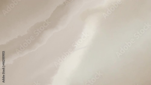 Cream colored fuzzy fabric effect blowing in the wind.