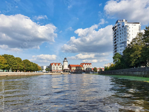 Embankment of the Fish Village with decorative lighthouse and houses in old historical Prussian style. Famous tourist attraction of Kaliningrad city, Russia (formerly Koenigsberg). photo