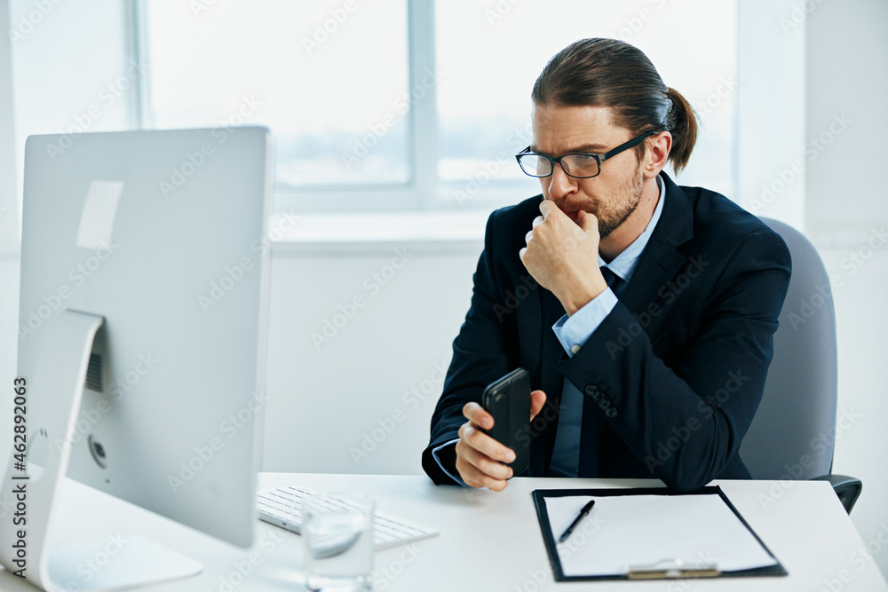 The man in a suit with glasses self-confidence work computer The man in a suit with glasses self-confidence work computer